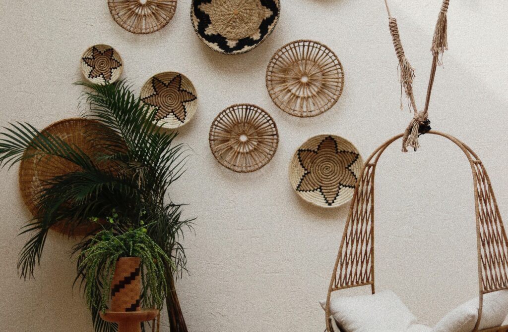 hanging rope chair next to tables and plant with decorative rope wall features in the background