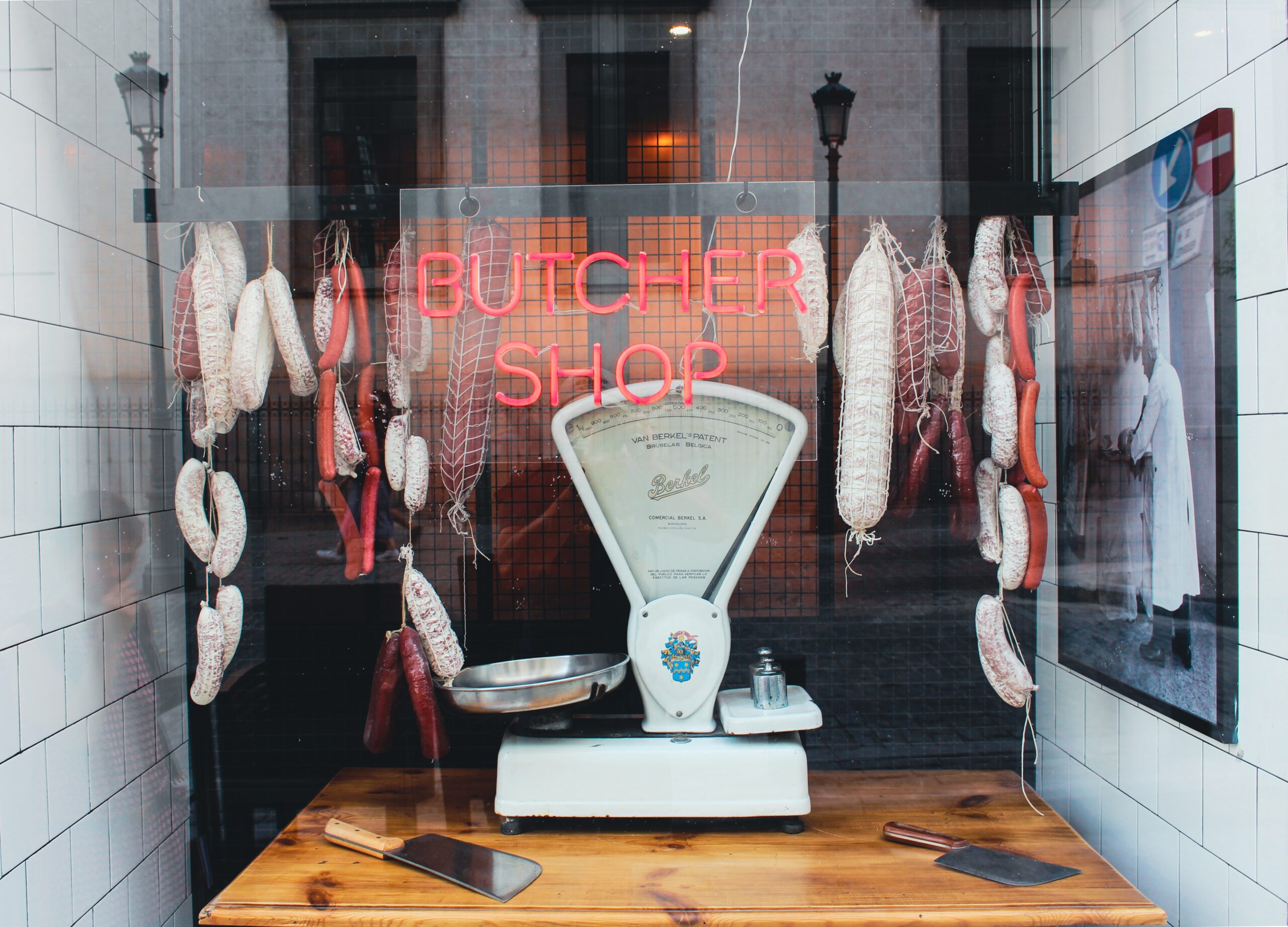 meat strung up in a butcher's window using butcher's twine